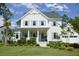 Charming two-story home featuring light blue shutters, a welcoming front porch, and beautifully landscaped yard at 1723 Bolden Dr, Mount Pleasant, SC 29466