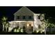 Beautiful two-story home illuminated at night with professional landscaping lights at 1723 Bolden Dr, Mount Pleasant, SC 29466