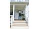 Charming front entrance boasting a light blue door, white columns, stylish lanterns, and wooden stairs at 1723 Bolden Dr, Mount Pleasant, SC 29466
