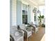 Relaxing front porch featuring wicker chairs, blue shutters, and charming decor for comfortable outdoor living at 1723 Bolden Dr, Mount Pleasant, SC 29466