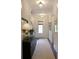 Inviting hallway with a dark wood floors, white walls, stylish lighting, and a view of the staircase at 1723 Bolden Dr, Mount Pleasant, SC 29466