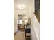 Bright hallway with a view into the living room, featuring dark wood floors and neutral décor at 1723 Bolden Dr, Mount Pleasant, SC 29466