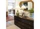 Elegant hallway with dark wood floors, a stylish dresser, and a glimpse of the dining area at 1723 Bolden Dr, Mount Pleasant, SC 29466