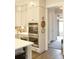 Kitchen showcasing double ovens, white cabinets, and hardwood floors that transition into the hallway at 1723 Bolden Dr, Mount Pleasant, SC 29466