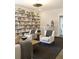 Cozy living room with a large bookshelf, comfortable armchairs, and a neutral color palette at 1723 Bolden Dr, Mount Pleasant, SC 29466