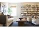Inviting living room with a cozy sofa, armchairs, and a large bookshelf filled with books and decor at 1723 Bolden Dr, Mount Pleasant, SC 29466