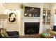 Cozy living room with a fireplace, built-in shelves, and stylish furnishings illuminated by a modern lamp at 1723 Bolden Dr, Mount Pleasant, SC 29466