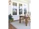 Inviting porch with a wooden table, wicker chairs, potted plants and a patterned rug at 1723 Bolden Dr, Mount Pleasant, SC 29466