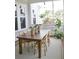 Inviting porch features a wooden table with wicker chairs and potted plants at 1723 Bolden Dr, Mount Pleasant, SC 29466