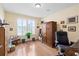 Well-lit home office with hardwood floors, shuttered windows, and plenty of storage at 175 Basket Grass Ln, Summerville, SC 29486