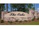 Elegant entrance sign with decorative stone and lush landscaping welcomes you to 'The Oaks' at 175 Basket Grass Ln, Summerville, SC 29486