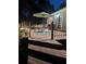 Back deck at night with table, chairs, and decorative lights at 189 Fox Chase Dr, Goose Creek, SC 29445