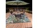 Back deck at night with table, chairs, outdoor umbrella, and decorative lights at 189 Fox Chase Dr, Goose Creek, SC 29445