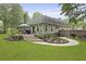 Charming home with a spacious backyard, wooden deck with an umbrella, and landscaped garden at 189 Fox Chase Dr, Goose Creek, SC 29445