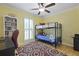 Bright bedroom features a bunk bed, ceiling fan, desk, and natural light from the large window at 189 Fox Chase Dr, Goose Creek, SC 29445