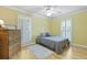 Bright bedroom features a ceiling fan, wood floors, and plentiful natural light from the large windows at 189 Fox Chase Dr, Goose Creek, SC 29445