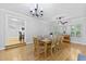 Dining room with hardwood floors, chandelier and view into kitchen at 189 Fox Chase Dr, Goose Creek, SC 29445