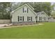 Well-maintained home with green siding, black shutters, and manicured landscaping at 189 Fox Chase Dr, Goose Creek, SC 29445