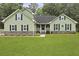 Charming home featuring green siding, black shutters, and a lush green lawn at 189 Fox Chase Dr, Goose Creek, SC 29445