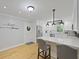 Charming white kitchen featuring modern appliances, quartz countertops, and a lovely breakfast bar with seating for casual dining at 189 Fox Chase Dr, Goose Creek, SC 29445