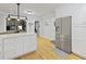 Spacious kitchen featuring stainless steel refrigerator, white cabinets, and island with bar seating, creating an inviting atmosphere at 189 Fox Chase Dr, Goose Creek, SC 29445