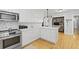A well-appointed white kitchen boasts a stainless steel oven and microwave and ample cabinetry at 189 Fox Chase Dr, Goose Creek, SC 29445