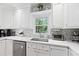 Bright kitchen showcases sleek stainless-steel appliances, white cabinets, quartz counters, and a decorative tile backsplash at 189 Fox Chase Dr, Goose Creek, SC 29445