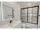 Modern bathroom with a white vanity, illuminated mirror, and black framed glass shower enclosure at 1906 Gumwood Blvd, North Charleston, SC 29406