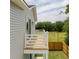 Side view of a wooden deck with white railings, overlooking a well maintained green backyard at 1906 Gumwood Blvd, North Charleston, SC 29406