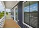 Covered deck with wood flooring and white railing, great for outdoor relaxation and entertainment at 1906 Gumwood Blvd, North Charleston, SC 29406