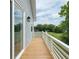 Side view of a wooden deck with white railings, overlooking a lush green backyard at 1906 Gumwood Blvd, North Charleston, SC 29406