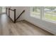 Hallway featuring wood floors, a stairway with wood railing and large windows for a natural living style at 1906 Gumwood Blvd, North Charleston, SC 29406