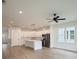 Open kitchen and living area with stainless steel appliances, large windows and a ceiling fan at 1906 Gumwood Blvd, North Charleston, SC 29406