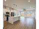Modern kitchen and living area featuring stainless steel appliances, white cabinets, and modern light fixtures at 1906 Gumwood Blvd, North Charleston, SC 29406