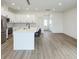 Open kitchen and living area with stainless steel appliances and large island with bar stool seating at 1906 Gumwood Blvd, North Charleston, SC 29406
