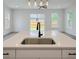 Kitchen island featuring a sink and black faucet with backyard views at 1906 Gumwood Blvd, North Charleston, SC 29406