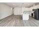 Open kitchen and living area featuring stainless steel appliances, white cabinets, and modern light fixtures at 1906 Gumwood Blvd, North Charleston, SC 29406