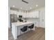 Modern kitchen with stainless steel appliances, white cabinets and an island with bar stool seating at 1906 Gumwood Blvd, North Charleston, SC 29406
