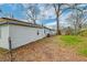 Exterior side view of home with siding, nestled in a leafy backyard with blue trim at 20 Stratton Dr, Charleston, SC 29420