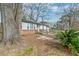 Exterior side view of home with brick and siding, complemented by mature trees and a spacious lot at 20 Stratton Dr, Charleston, SC 29420