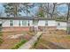 Charming single-story home with brick and siding, complemented by mature trees and a spacious lot at 20 Stratton Dr, Charleston, SC 29420