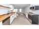 Bright, open kitchen with stainless steel appliances, wood countertops, and new floors leads to living area at 20 Stratton Dr, Charleston, SC 29420