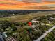Expansive aerial view shows a home nestled among lush greenery with views of the surrounding landscape at 200 Wappoo Rd, Charleston, SC 29407