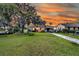Lovely home exterior features a long driveway, ample yard space, and a covered parking area at 200 Wappoo Rd, Charleston, SC 29407
