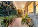 Picturesque front porch with hanging plants offers a relaxing outdoor space at sunset at 200 Wappoo Rd, Charleston, SC 29407