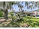 Inviting outdoor seating area and a well-kept front yard, shaded by mature trees at 200 Wappoo Rd, Charleston, SC 29407