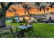Inviting front yard with a table, chairs, and mature trees offering ample shade at 200 Wappoo Rd, Charleston, SC 29407
