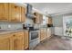 Functional kitchen with stainless steel appliances, wooden cabinets, and a large sink at 200 Wappoo Rd, Charleston, SC 29407
