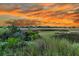Scenic marsh view with a colorful sunset provides a tranquil and picturesque backdrop at 200 Wappoo Rd, Charleston, SC 29407