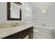Stylish bathroom with a modern vanity, soaking tub, and decorative lighting at 2060 Wappoo Hall Rd, Charleston, SC 29412